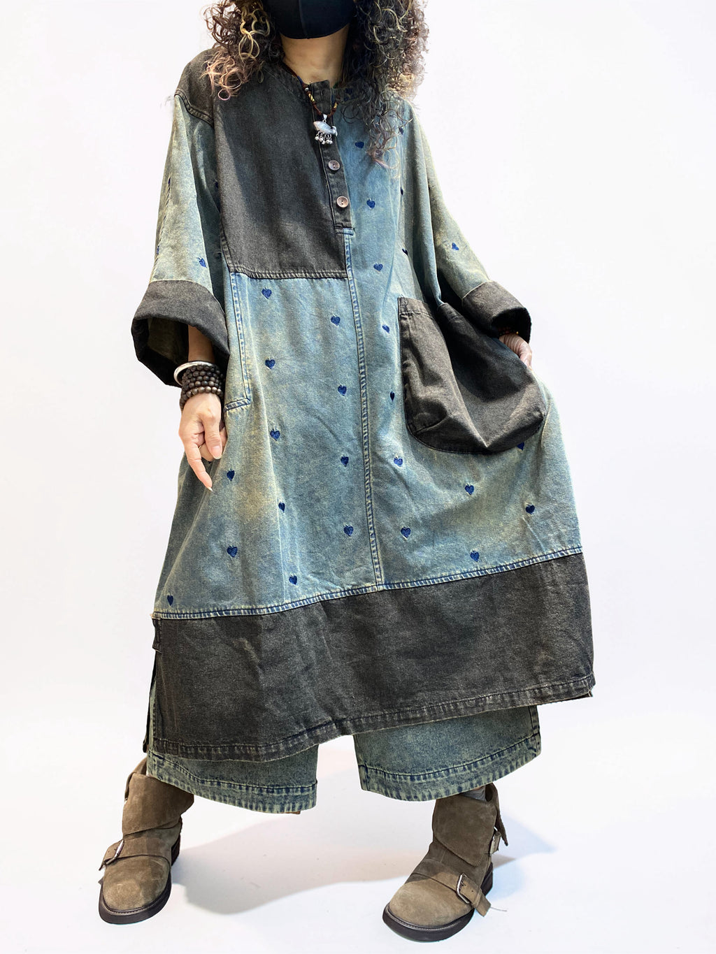 Oversized denim dress styled with boots