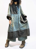 Oversized denim dress styled with boots