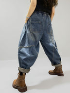 Back view of vintage washed denim harem pants with an oversized silhouette.