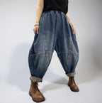 Oversized blue patchwork denim harem pants with a relaxed balloon silhouette and elastic waist.