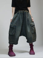Blue vintage washed denim cargo harem pants with relaxed oversized fit.