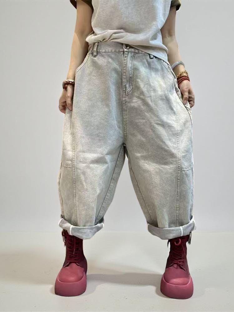 Front view of vintage washed baggy denim pants with rolled hems.