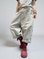 Model walking in oversized baggy cotton denim harem jeans.