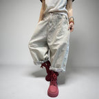 Oversized light gray baggy harem jeans with a drop crotch, rolled cuffs, and relaxed fit.