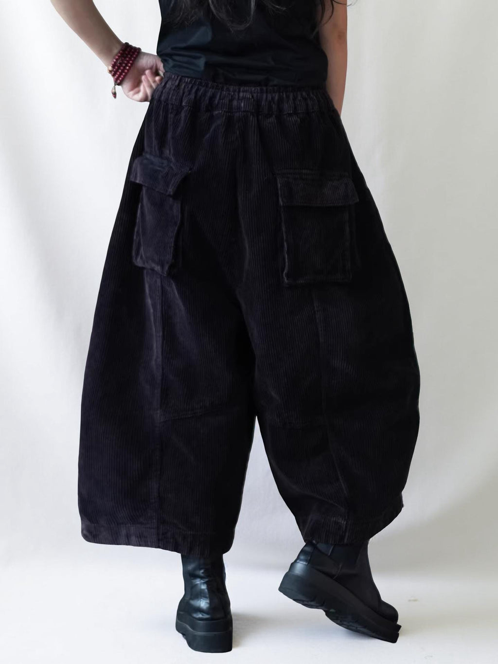 Back view of oversized corduroy balloon pants with an elastic waistband.