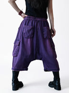 Back view of vintage washed denim cargo harem pants with elastic waistband.