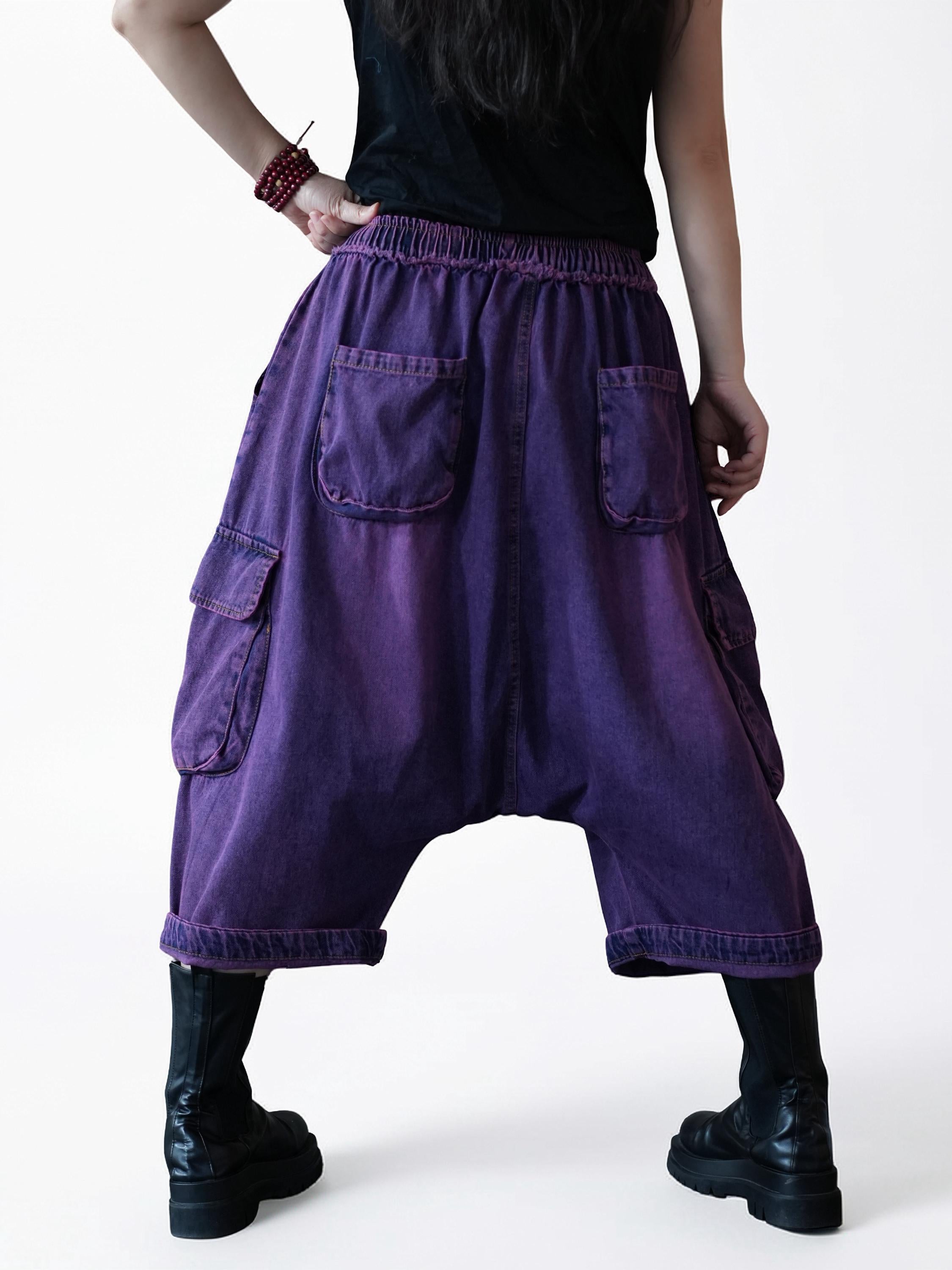 Back view of vintage washed denim cargo harem pants with elastic waistband.