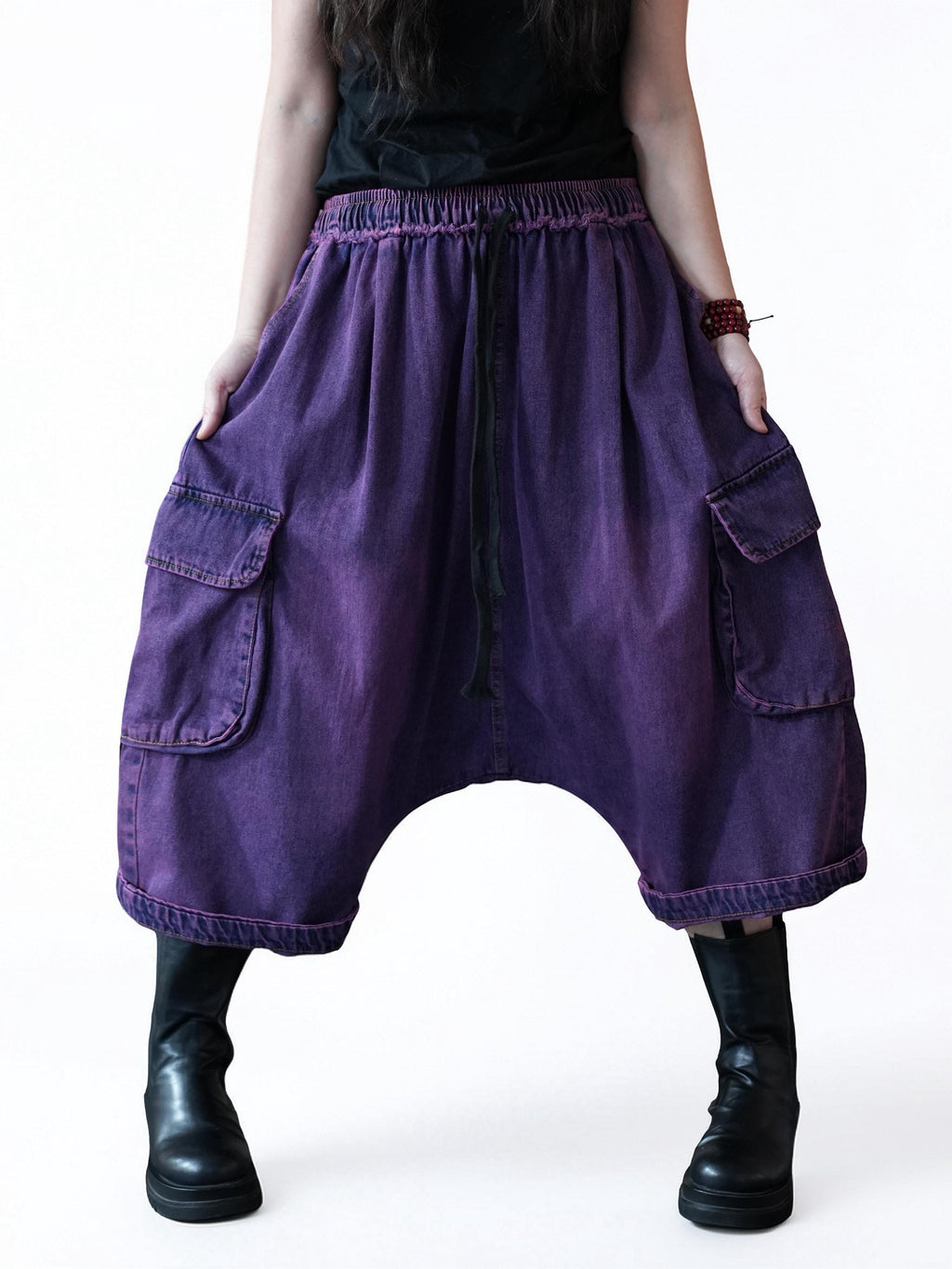 Front view of vintage washed denim cargo harem pants with oversized relaxed fit.