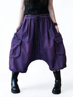 Front view of vintage washed denim cargo harem pants with oversized relaxed fit.