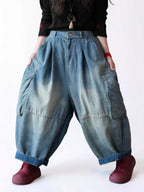 Vintage washed blue balloon jeans with oversized cargo pockets and a relaxed fit.