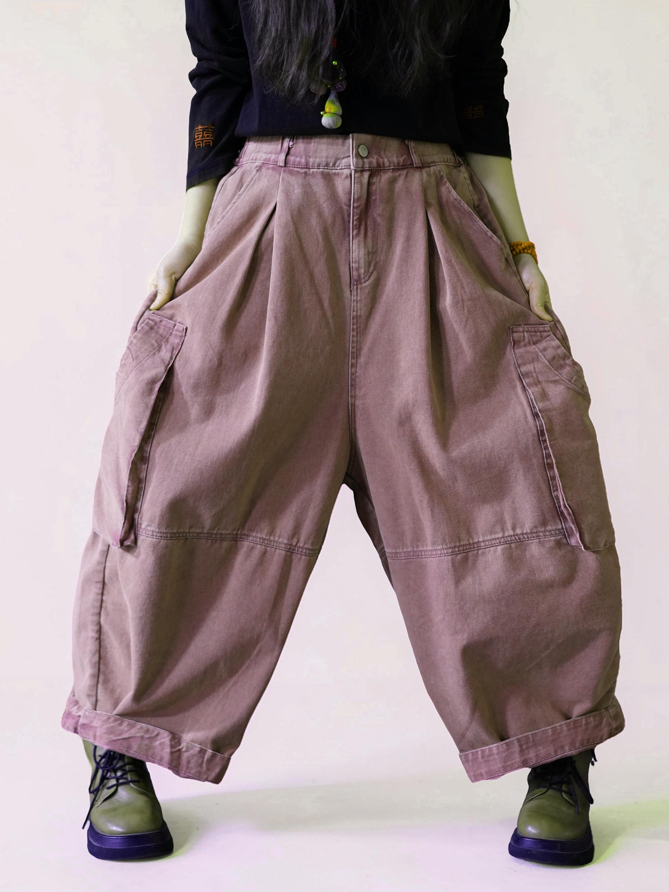 Front view of oversized dusty pink cargo balloon pants with a high waist.