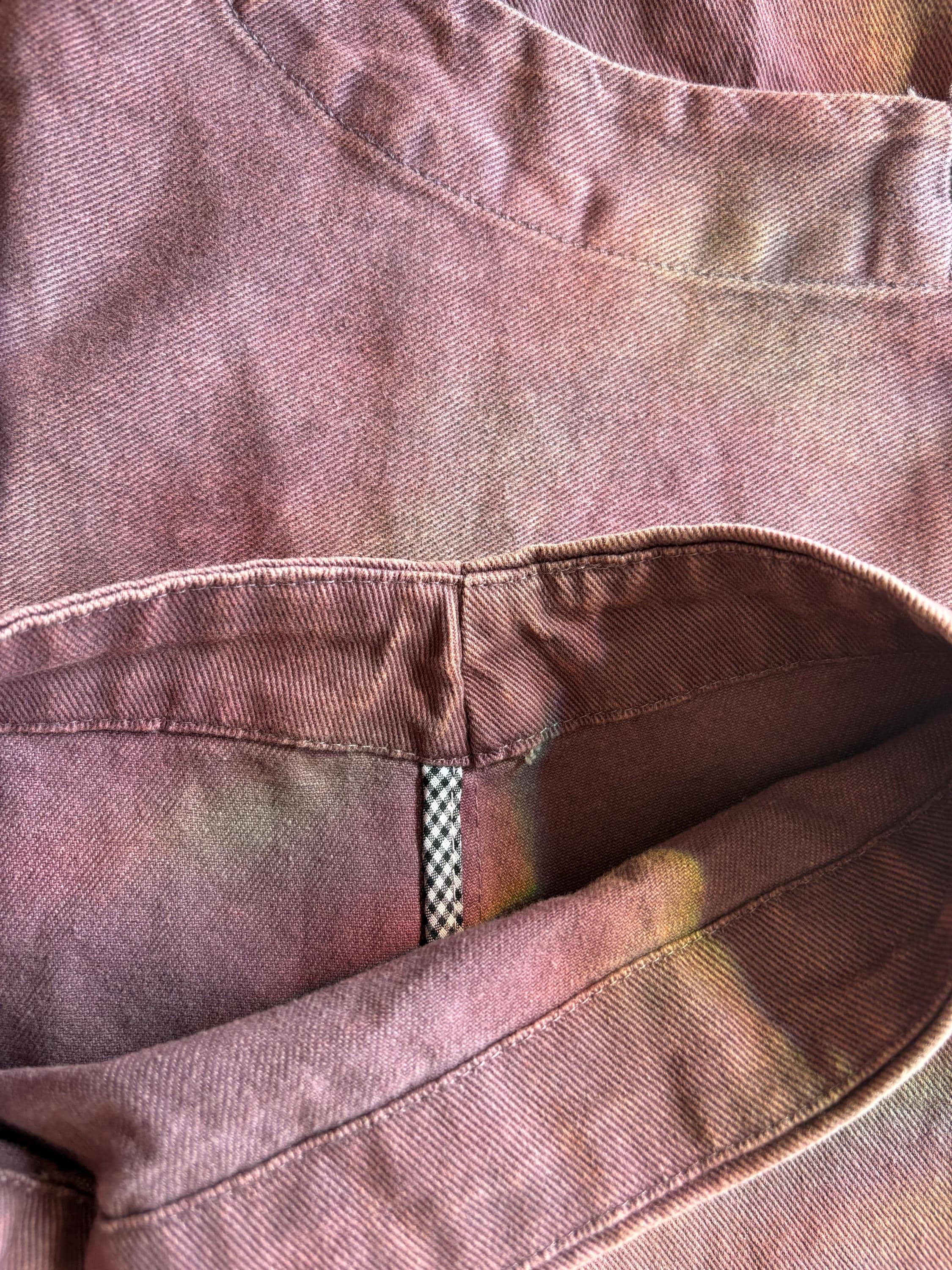 Close-up of vintage washed cotton fabric with rich tonal variation, artisan-dyed color shifts, and detailed stitching.