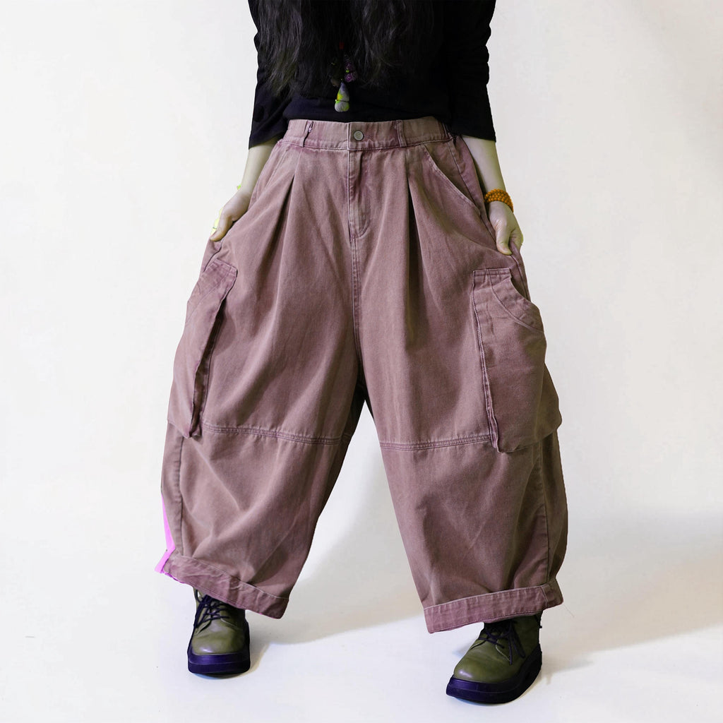 Vintage washed dusty pink balloon workwear pants with a high waist and oversized cargo pockets.