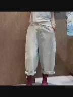Model wearing oversized cotton denim harem jeans in motion.