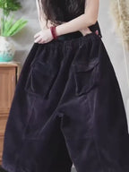 Oversized cropped corduroy pants in motion showing the relaxed fit.