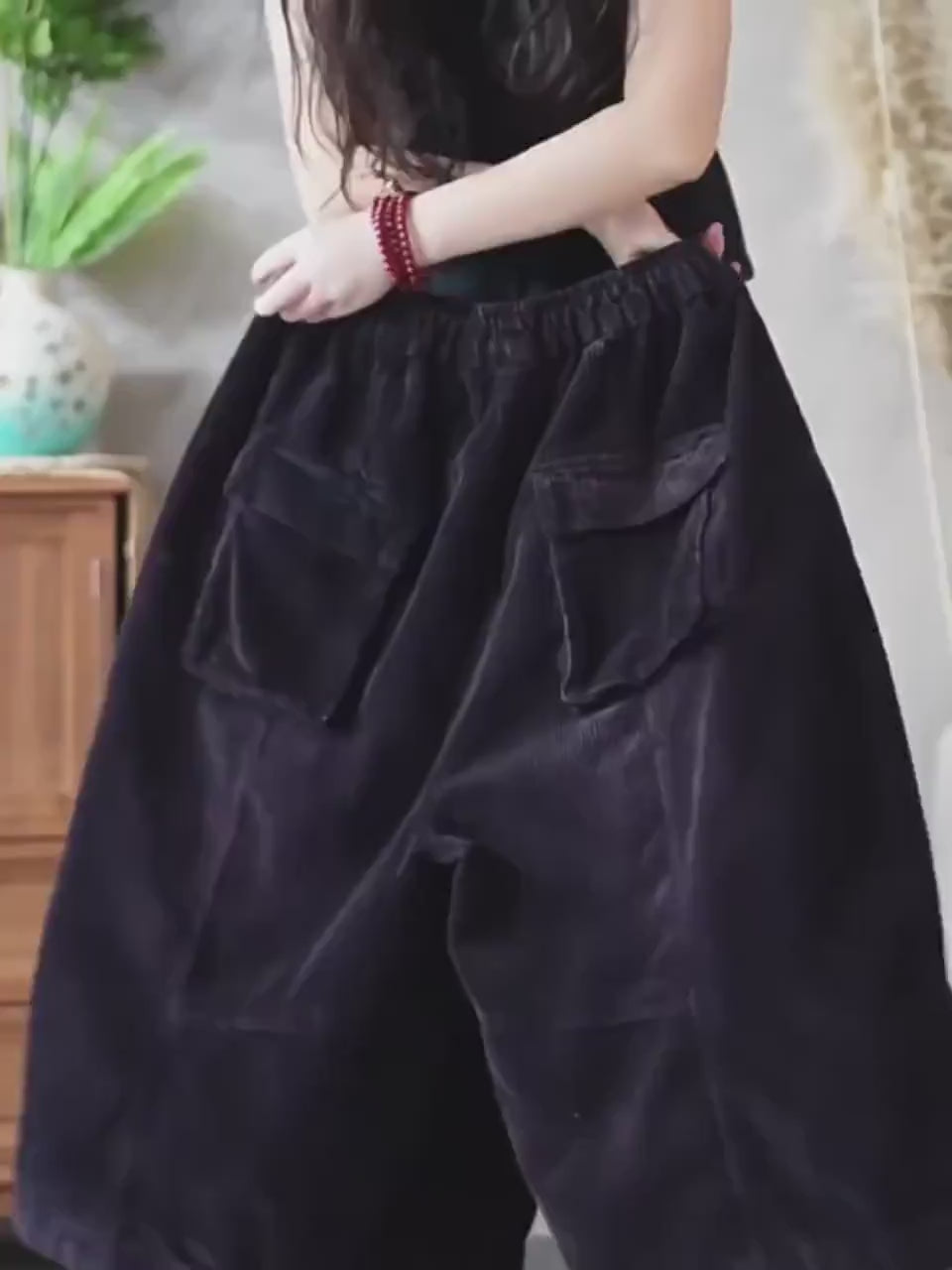 Oversized cropped corduroy pants in motion showing the relaxed fit.