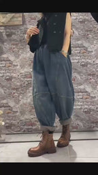 Model wearing oversized patchwork denim harem pants in motion.