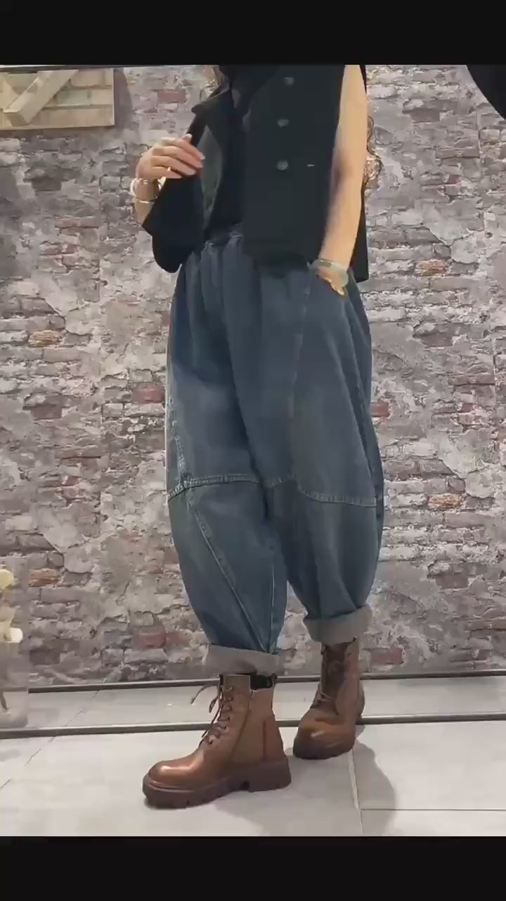 Model wearing oversized patchwork denim harem pants in motion.